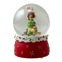 Djed Božićnjak ukrašava božićno drvce glazbenom snježnom kuglom koja ukrašava ploču stola